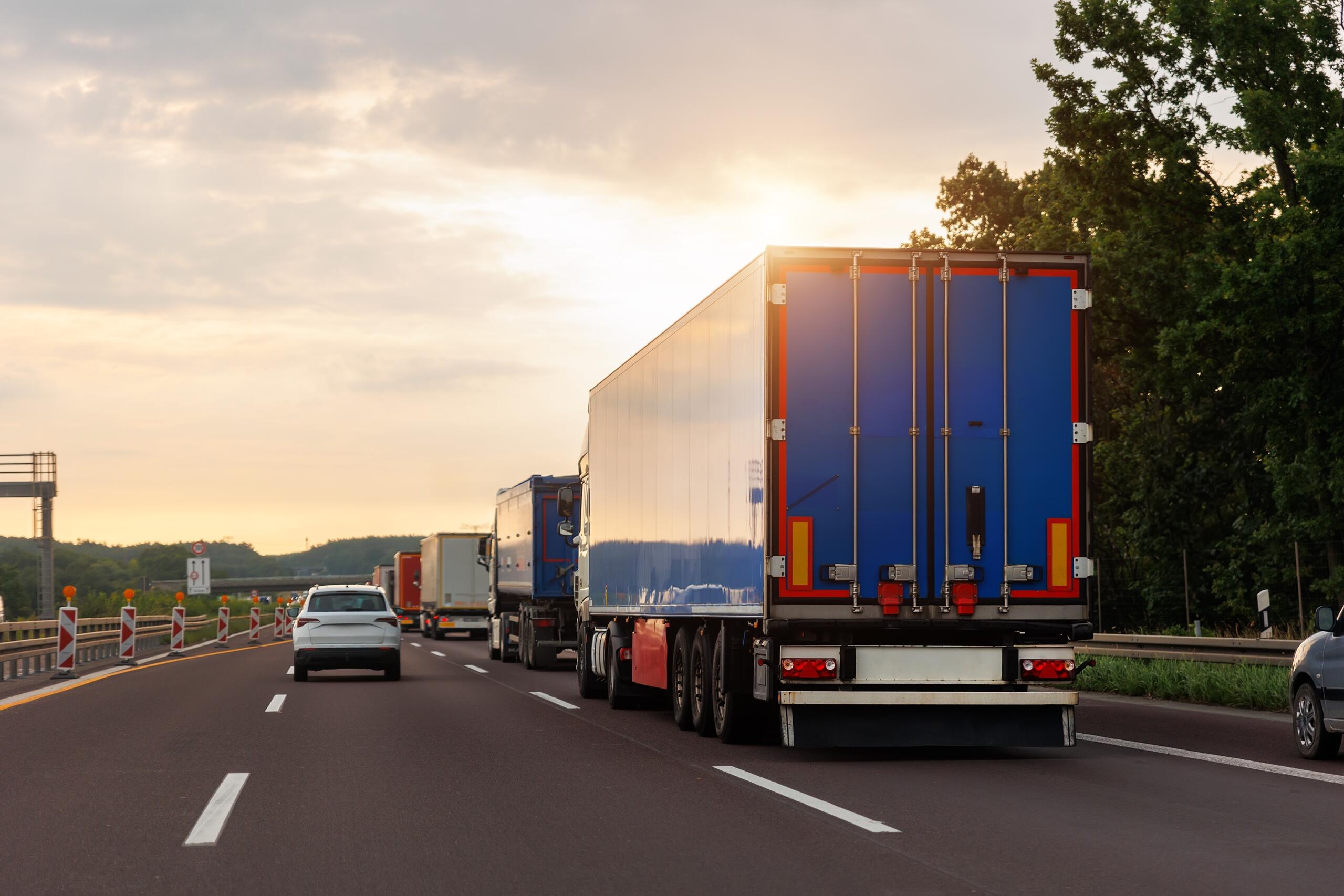 Commercial trucks on a Washington highway, highlighting vicarious liability and who is liable in a truck accident
