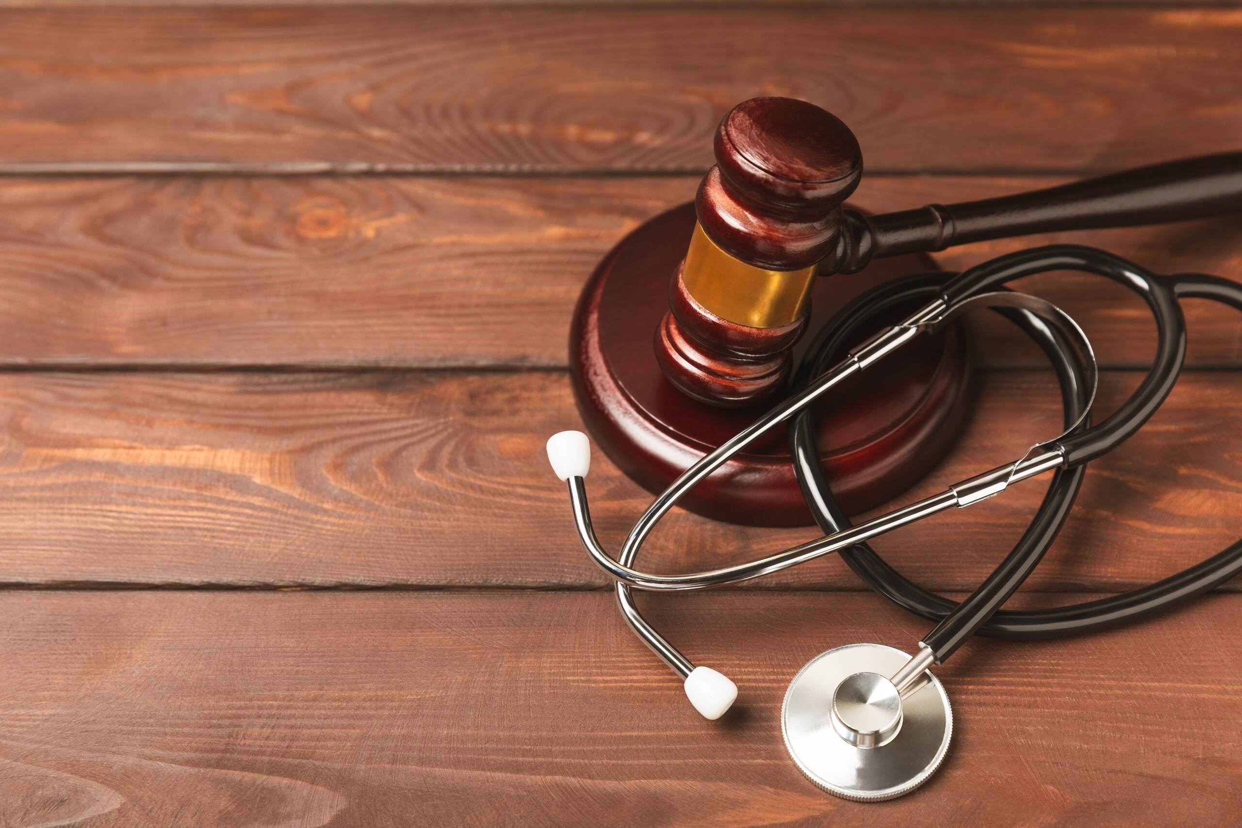 A legal gavel next to a stethoscope, representing the mandatory arbitration process for personal injury cases in Spokane.
